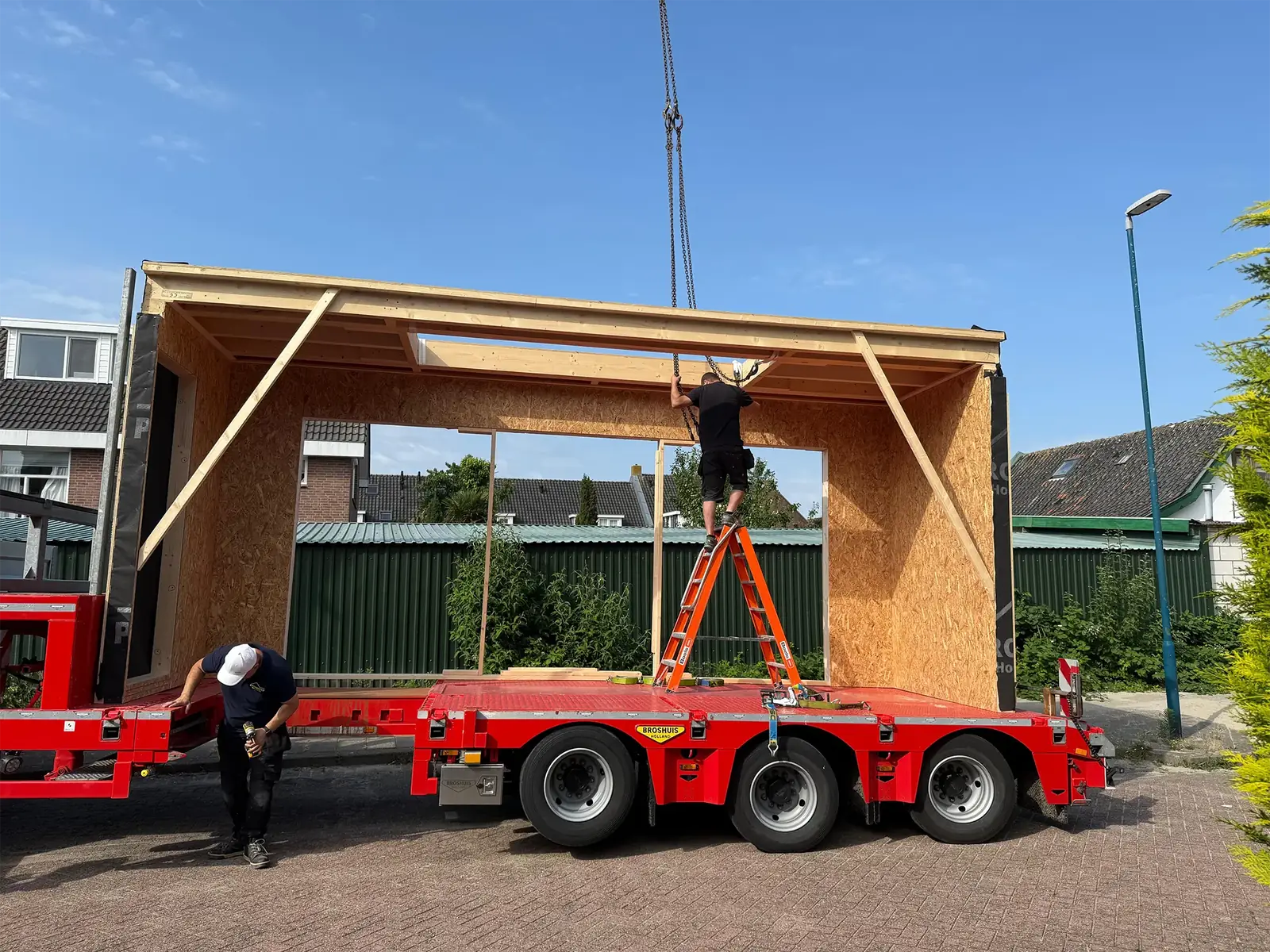Het prefab casco staat op de dieplader en wordt aangeslagen voor de kraan.